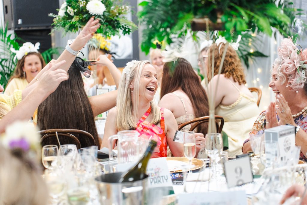 Guests celebrating a wedding-style event at Invercauld House in Goonellabah, surrounded by lush gardens and elegant event setup, capturing a joyful and festive atmosphere.